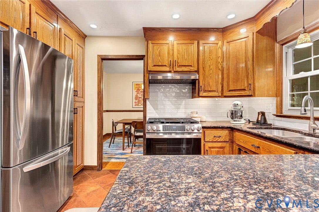 11410 Driscoll Road, Chester, VA 23831 Kitchen featuring wood cabinetry, stone countertops, stainless steel refrigerator, gas range with integrated vent hood, and white subway tile backsplash