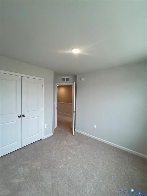 Soft gray carpeted flooring, light gray wall paint, and white trim