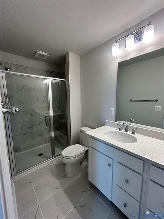 Spacious bathroom featuring a glass-enclosed shower with marble-style tile, a white vanity with an integrated sink and light-colored countertop, and a chrome light fixture