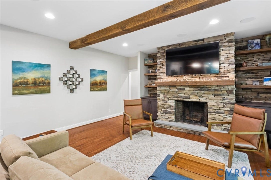 9013 Old Holly Road, Southhampton, Richmond, VA 23235 Stone fireplace with a substantial wood mantel, integrated shelving, and built-in cabinetry