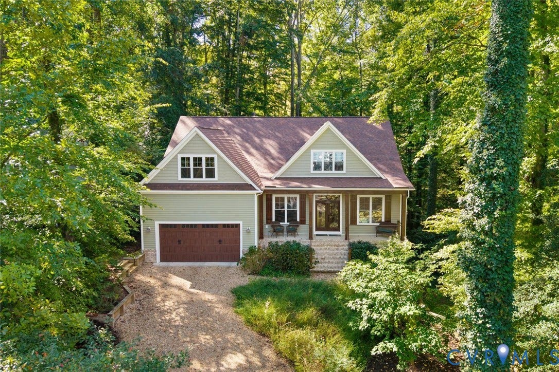 9013 Old Holly Road, Southhampton, Richmond, VA 23235 Siding exterior with dormer windows, covered front porch, attached garage, and gravel driveway