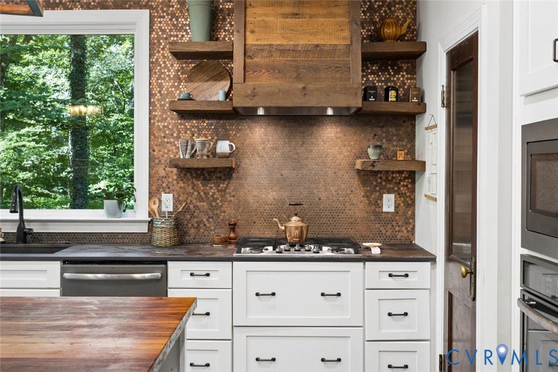 9013 Old Holly Road, Southhampton, Richmond, VA 23235 White shaker cabinetry with black hardware, copper penny tile backsplash, stainless steel dishwasher, gas range, and built-in microwave