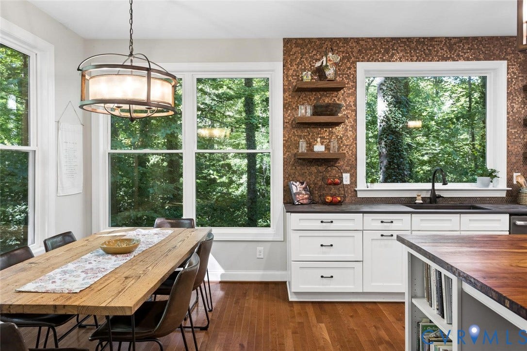 9013 Old Holly Road, Southhampton, Richmond, VA 23235 White shaker cabinetry with dark hardware, dark stone countertops, a bronze-toned backsplash, wood-finish flooring, and a contemporary light fixture