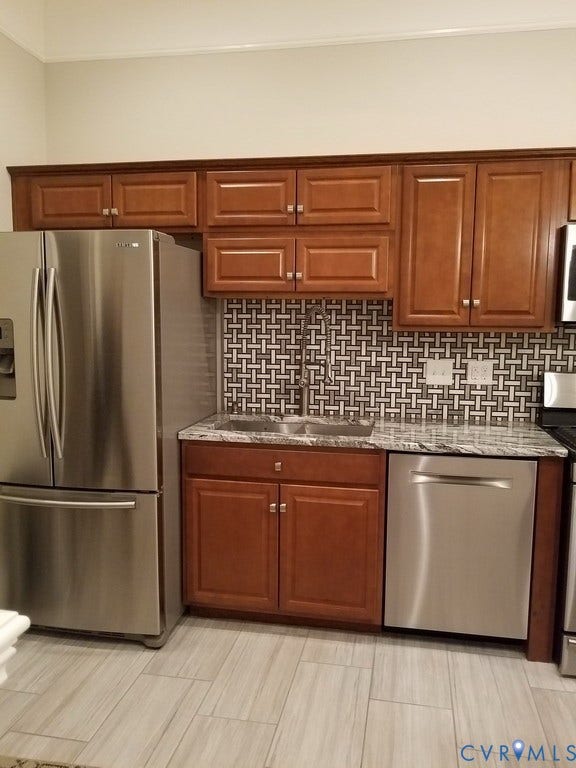 Wood-finish cabinetry paired with a decorative tile backsplash