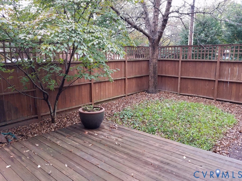 Wood-finish decking with a privacy fence featuring lattice detailing