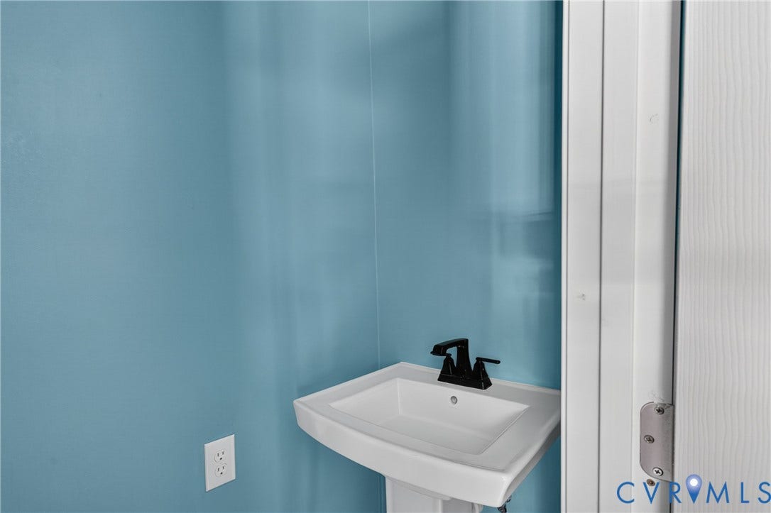 8211 Brills Road, Dinwiddie, VA 23872 Pedestal sink with a black faucet