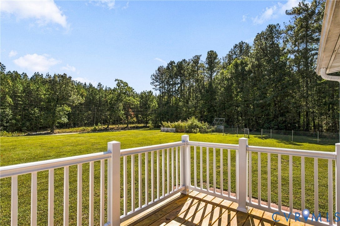 8211 Brills Road, Dinwiddie, VA 23872 Expansive lawn with mature trees, a wood-finish deck, and white railing