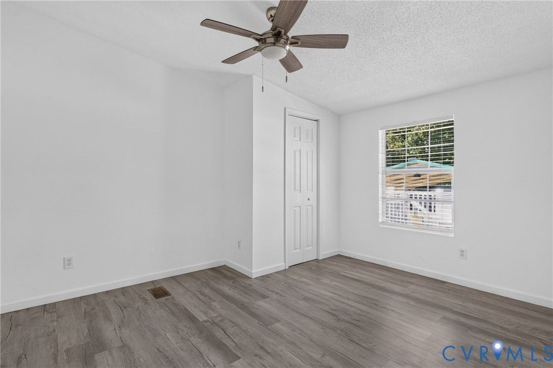 8211 Brills Road, Dinwiddie, VA 23872 Room featuring wood-finish flooring, a ceiling fan, and a window with blinds