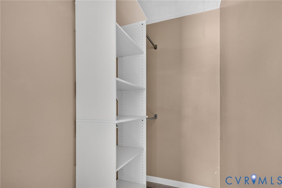 8211 Brills Road, Dinwiddie, VA 23872 Built-in shelving unit with multiple adjustable shelves and metal hanging rods