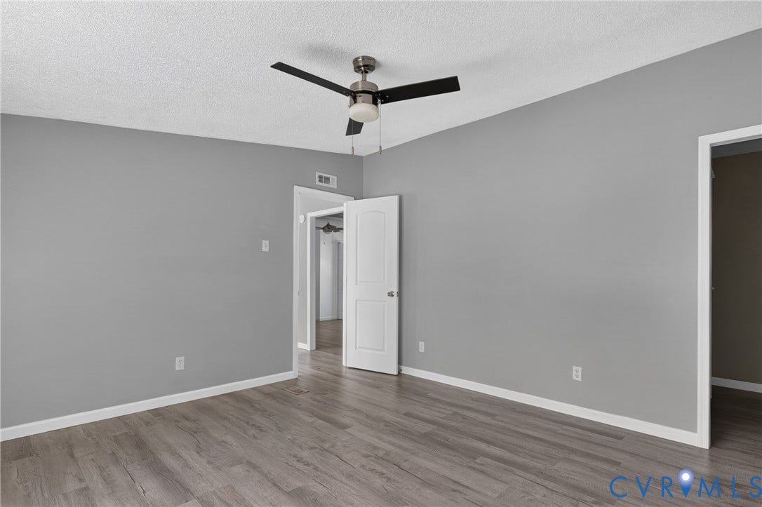 8211 Brills Road, Dinwiddie, VA 23872 Wood-finish flooring, neutral gray wall tones, ceiling fan with integrated lighting, and white trim