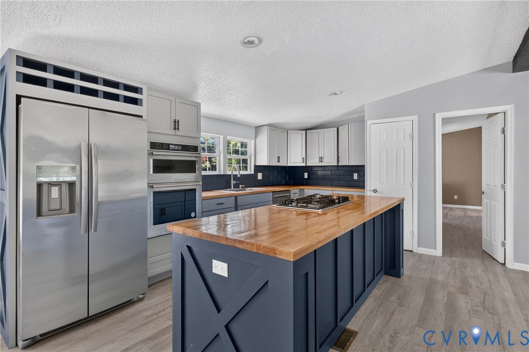 8211 Brills Road, Dinwiddie, VA 23872 Kitchen featuring a stainless steel refrigerator, built-in oven, blue tile backsplash, wood-finish countertops, and plank flooring