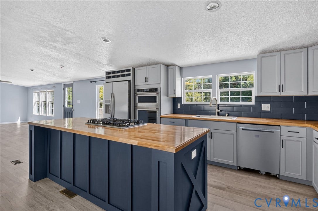 8211 Brills Road, Dinwiddie, VA 23872 Kitchen featuring a center island with a gas cooktop, light wood-finish countertops, stainless steel appliances, and grey cabinetry