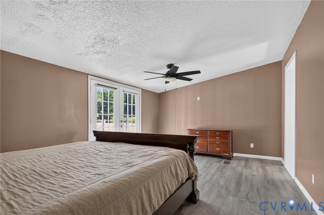 8211 Brills Road, Dinwiddie, VA 23872 French doors with multiple panes, wood-finish flooring, and a ceiling fan with light fixture
