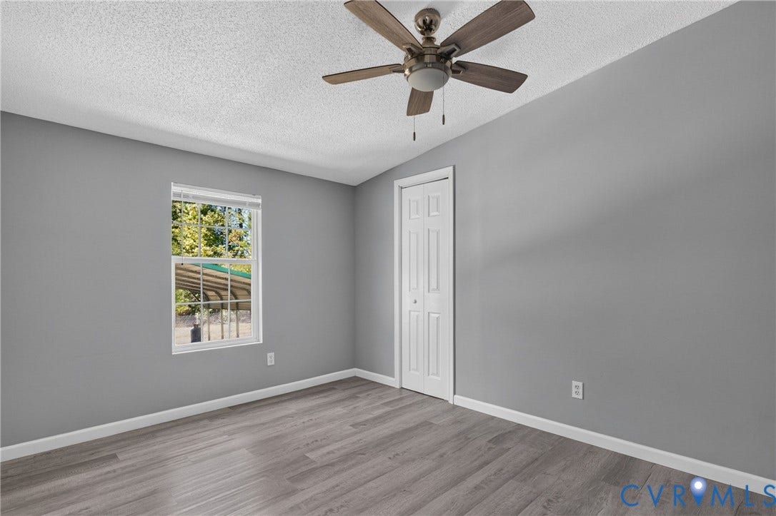 8211 Brills Road, Dinwiddie, VA 23872 Room featuring wood-finish flooring, a ceiling fan with integrated lighting, and a double-pane window