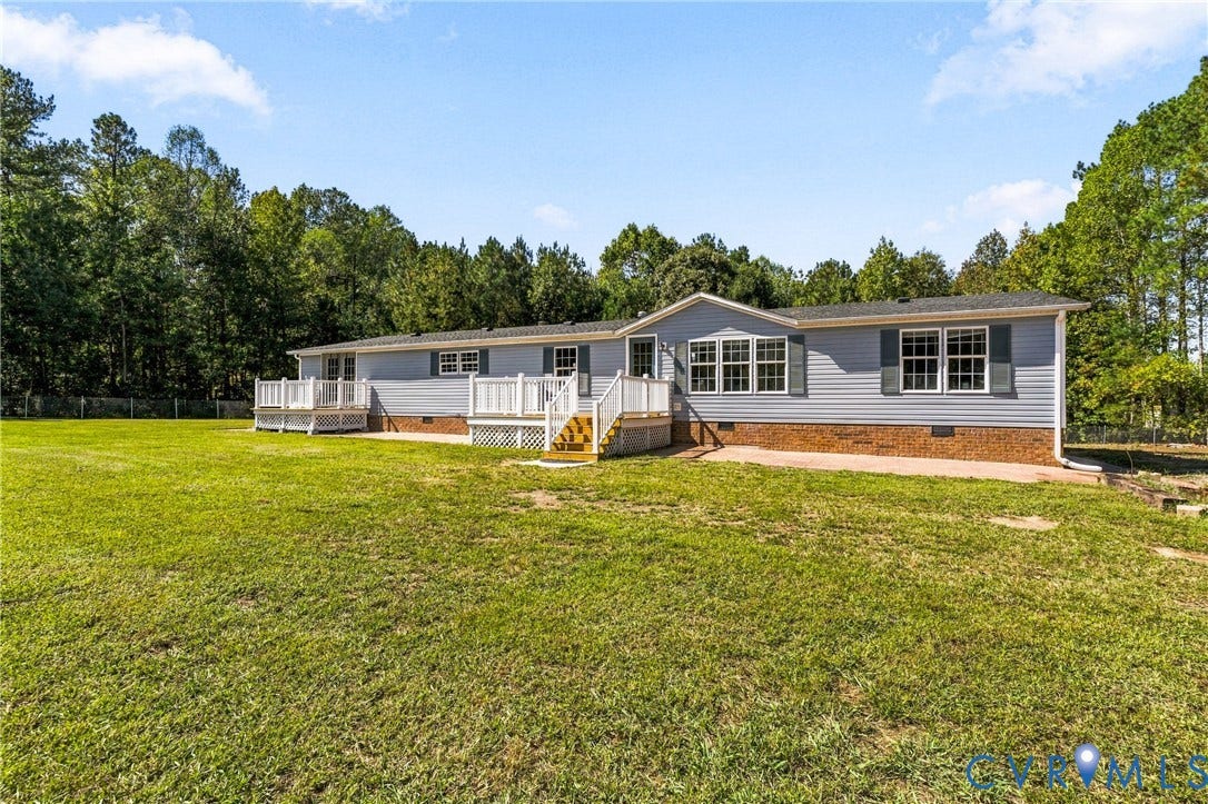 8211 Brills Road, Dinwiddie, VA 23872 Spacious property with a light blue siding exterior, white trim, and dark shutters