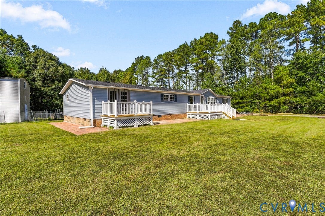 8211 Brills Road, Dinwiddie, VA 23872 Expansive lawn with mature trees and two exterior decks featuring white railings