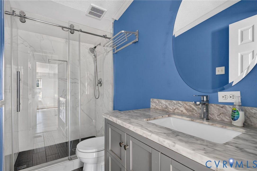 8211 Brills Road, Dinwiddie, VA 23872 Shower with sliding glass enclosure, wood-finish shower pan, and white tile surround