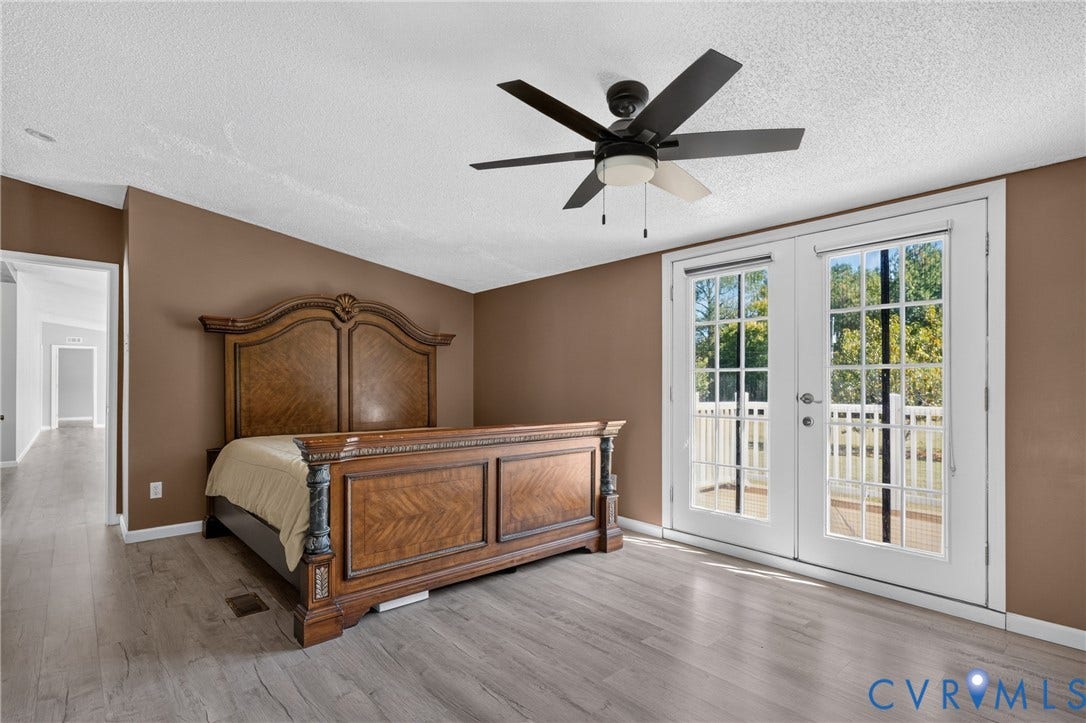 8211 Brills Road, Dinwiddie, VA 23872 Wood-finish flooring, ceiling fan with integrated lighting, and white French doors with divided lites opening to an outdoor area
