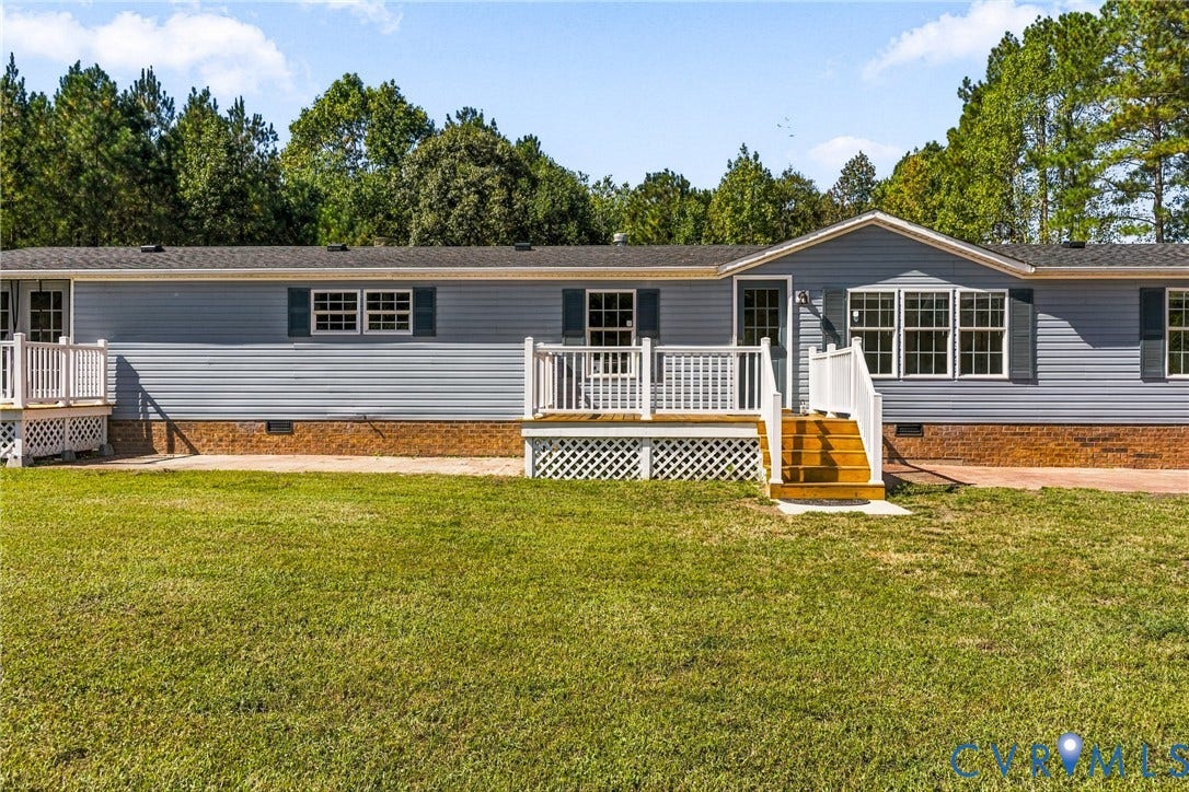 8211 Brills Road, Dinwiddie, VA 23872 Exterior featuring blue siding, white trim, a gabled entrance, and a front deck with white railings