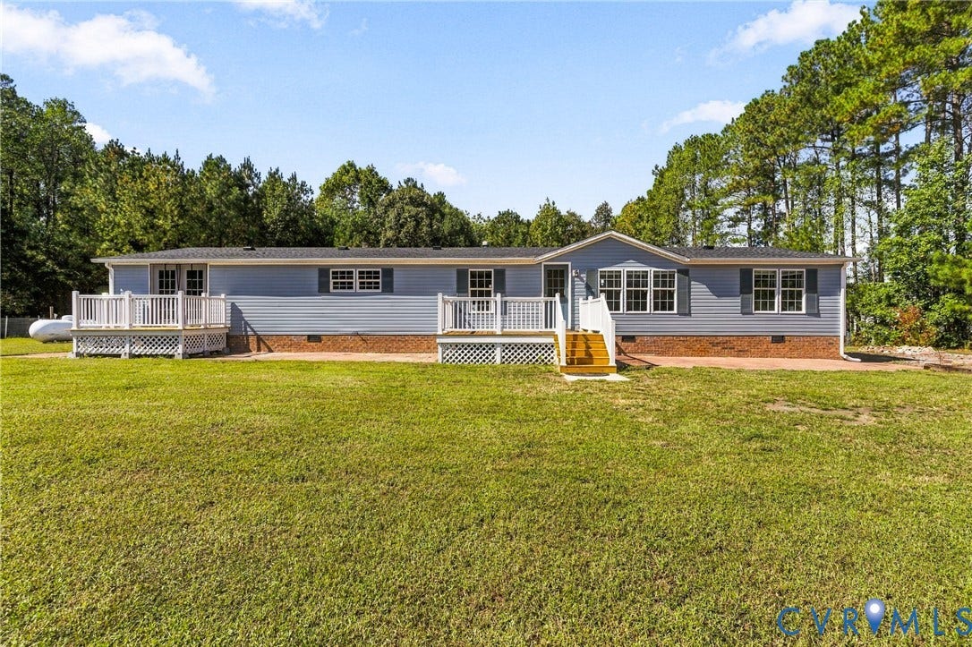 8211 Brills Road, Dinwiddie, VA 23872 Light blue siding exterior with white window trim and dark shutters