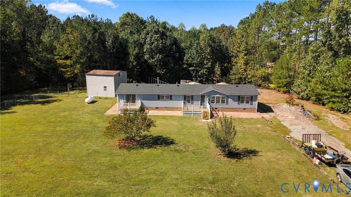 8211 Brills Road, Dinwiddie, VA 23872 Single-story residence featuring light blue siding, a dark roof, and a front porch
