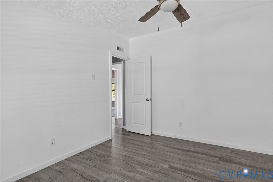 8211 Brills Road, Dinwiddie, VA 23872 Wood-finish flooring with white baseboards and light-toned walls