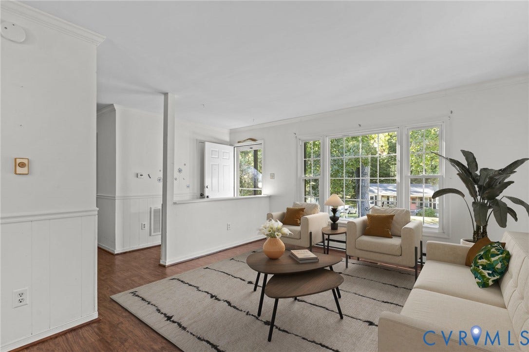 Hardwood-finish flooring, white paneled wainscoting, crown molding, and large multi-pane windows. Photo has been digitally staged.
