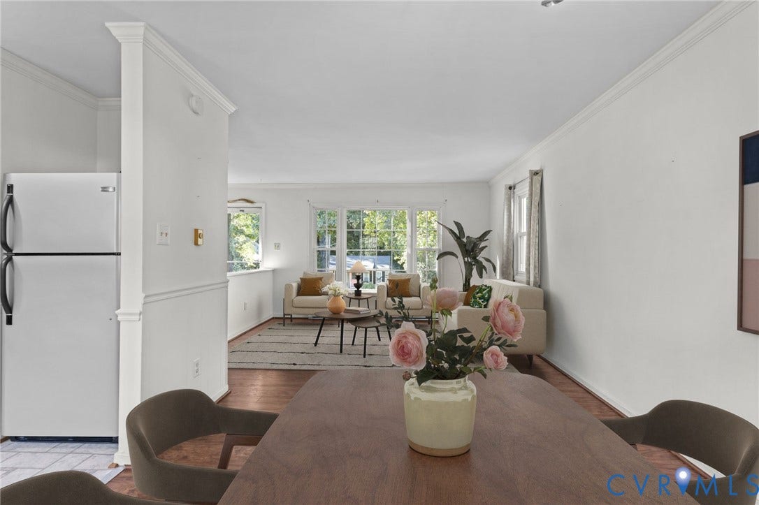 Hardwood-finish flooring, white painted walls and trim, crown molding, and chair rail detailing. Photo has been digitally staged.