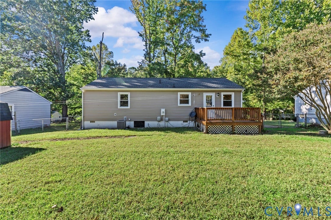 Back of home with large, flat, fenced yard- perfect for kids and pets!