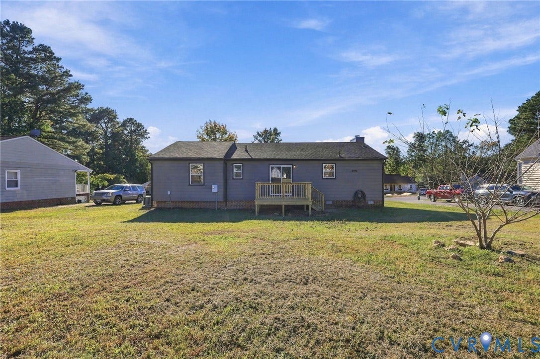 5113 Olympic Lane, North Dinwiddie, VA 23803 Rear exterior featuring a wood deck and a chimney