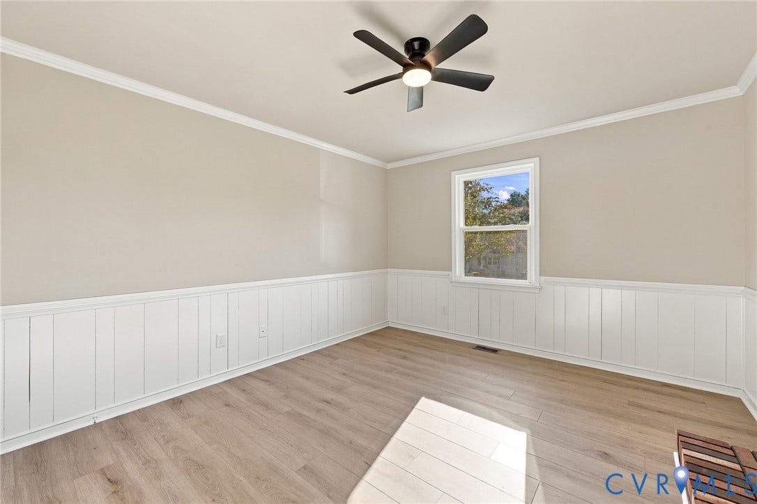 5113 Olympic Lane, North Dinwiddie, VA 23803 Neutral wall color, crown molding, wood-finish flooring, wainscoting, and a ceiling fan with integrated lighting