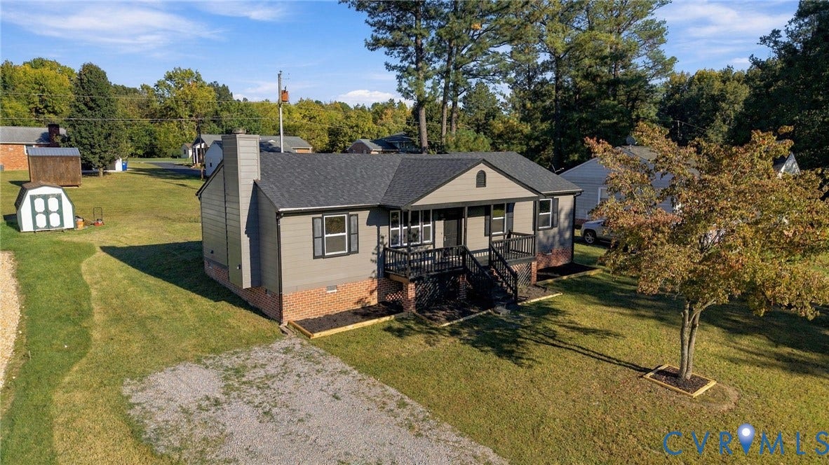 5113 Olympic Lane, North Dinwiddie, VA 23803 Ranch-style residence featuring a charcoal gray shingle roof, gray siding, and a brick foundation