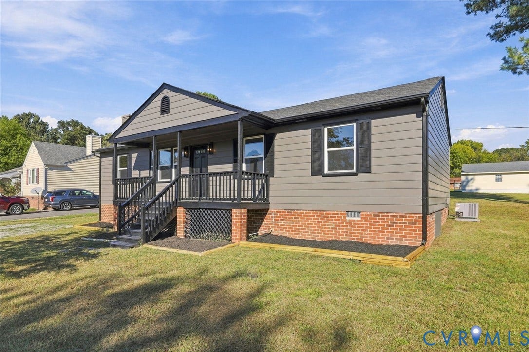 5113 Olympic Lane, North Dinwiddie, VA 23803 Gray siding exterior with black trim, covered porch, brick foundation, and dark shutters