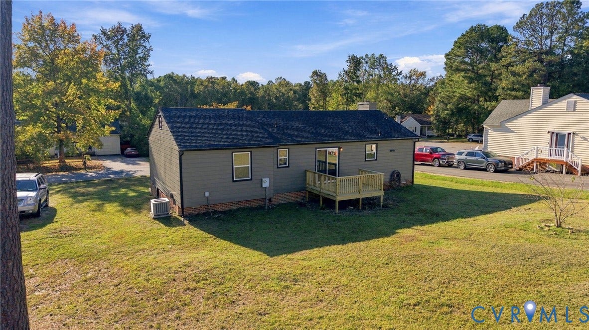 5113 Olympic Lane, North Dinwiddie, VA 23803 Rear exterior with a wood deck, dark shingle roof, and light gray siding