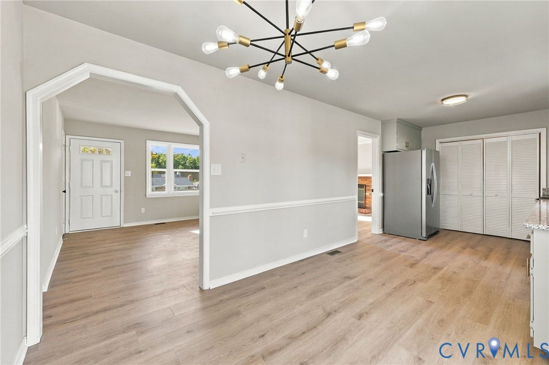 5113 Olympic Lane, North Dinwiddie, VA 23803 Wood-finish flooring throughout, modern sputnik chandelier, archway entry, and stainless steel refrigerator