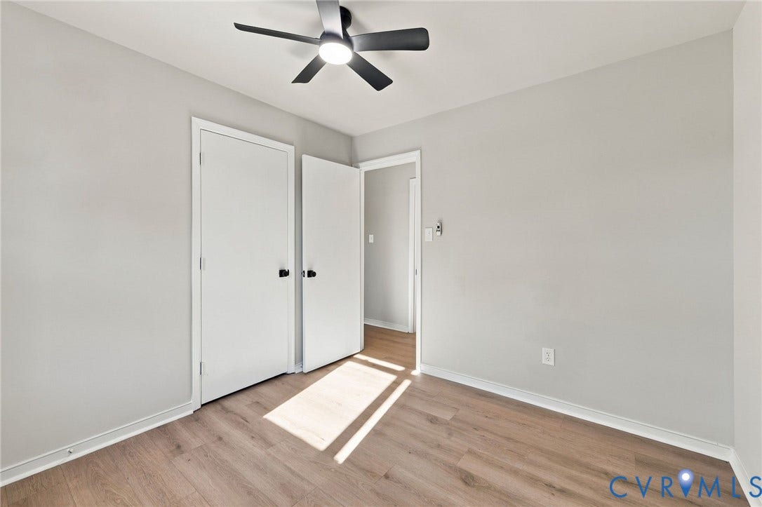 5113 Olympic Lane, North Dinwiddie, VA 23803 Wood-finish flooring, light gray walls, white trim, and a ceiling fan with integrated lighting