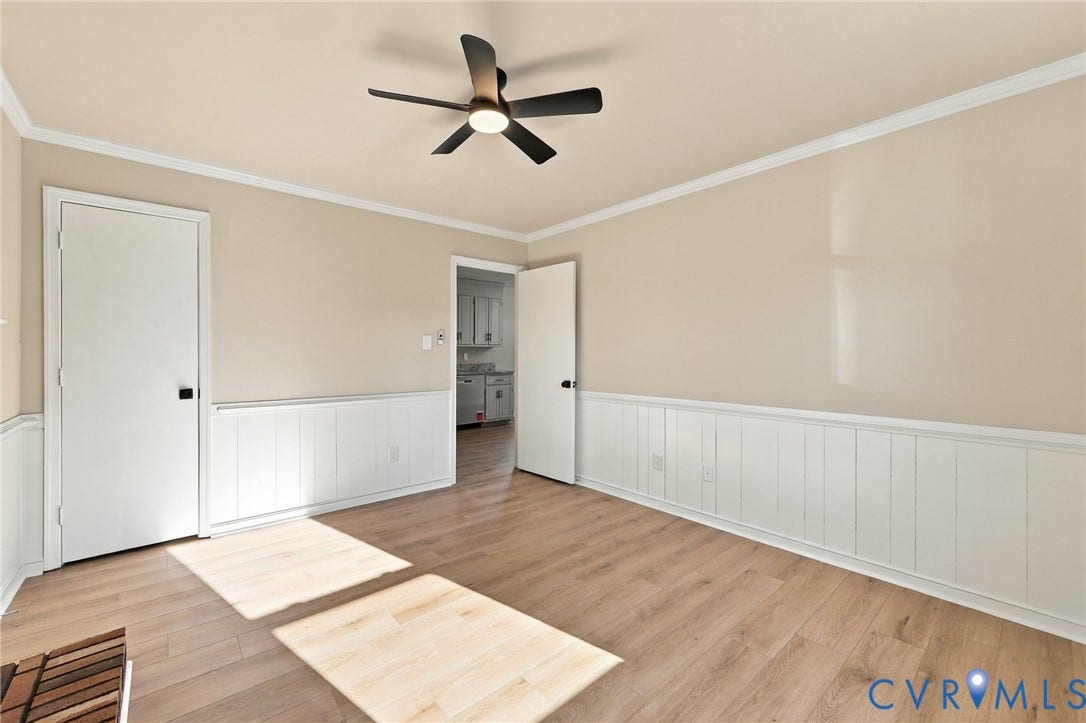 5113 Olympic Lane, North Dinwiddie, VA 23803 Wood-finish flooring, white panel wall detailing, crown molding, and a modern ceiling fan