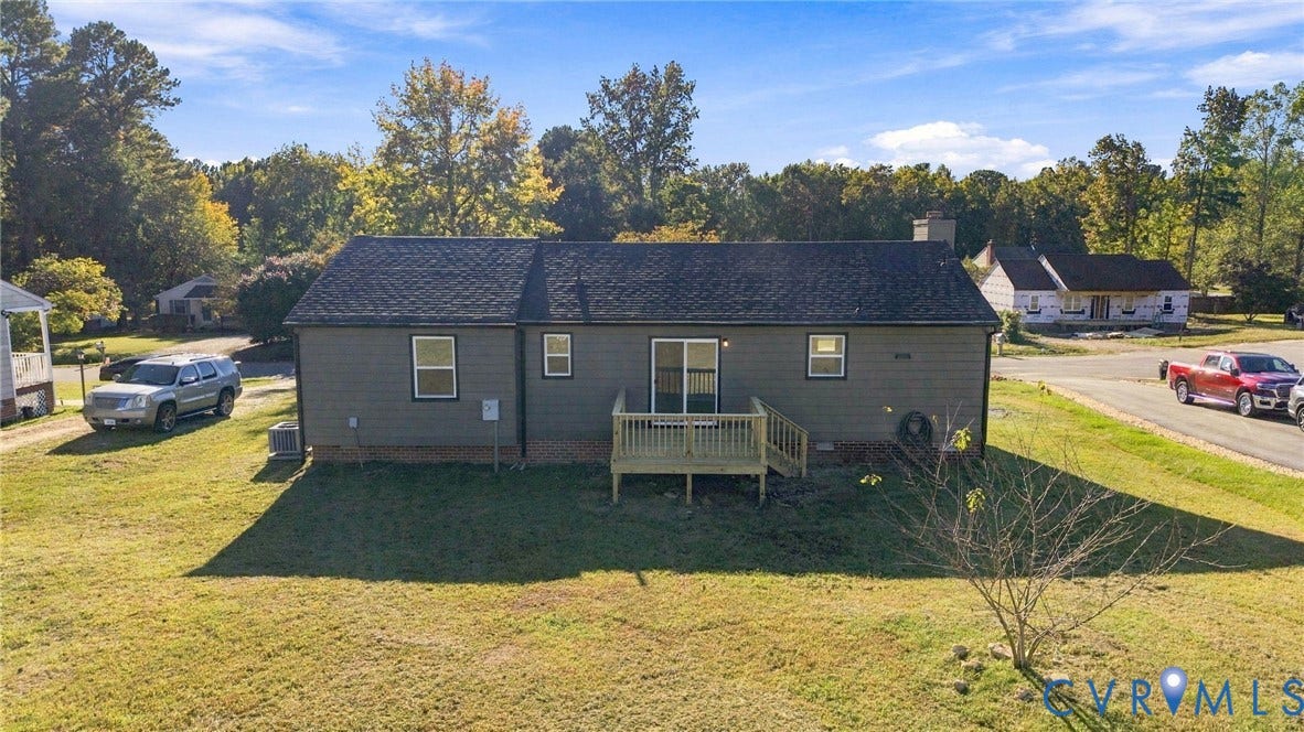 5113 Olympic Lane, North Dinwiddie, VA 23803 Rear exterior featuring gray siding, a wood deck, and a sliding glass door