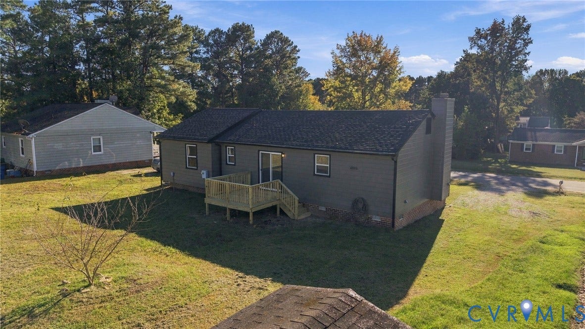 5113 Olympic Lane, North Dinwiddie, VA 23803 Rear exterior with wood decking, sliding glass door, and a shingle roof