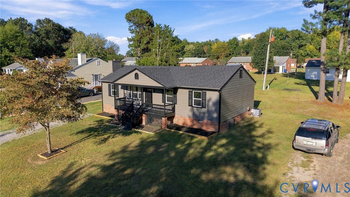 5113 Olympic Lane, North Dinwiddie, VA 23803 Ranch-style residence featuring a covered front porch with dark railings and steps