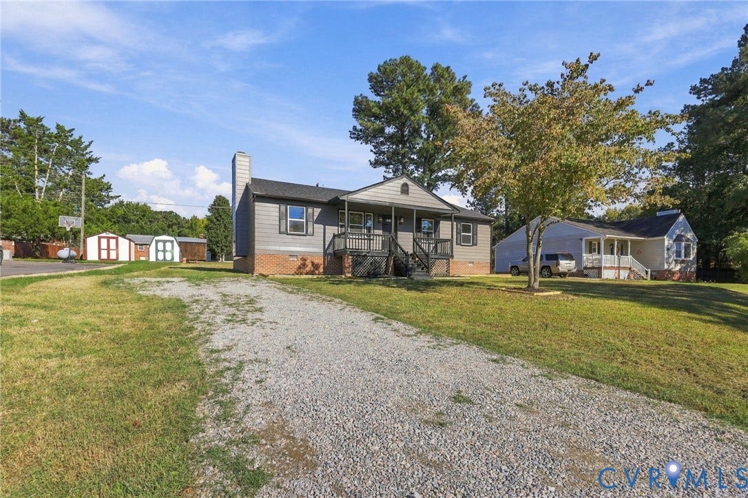 5113 Olympic Lane, North Dinwiddie, VA 23803 Gravel driveway with a wood-sided exterior, front porch, and mature trees