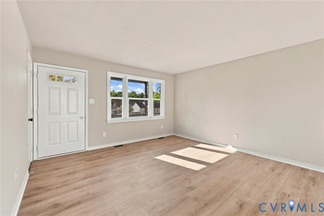 5113 Olympic Lane, North Dinwiddie, VA 23803 Wood-finish flooring, white paneled entrance door with decorative glass, and a large multi-pane window