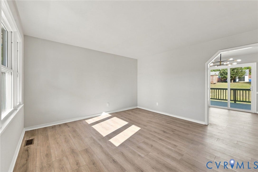 5113 Olympic Lane, North Dinwiddie, VA 23803 Wood-finish flooring throughout, bright white walls, and a large window with white trim