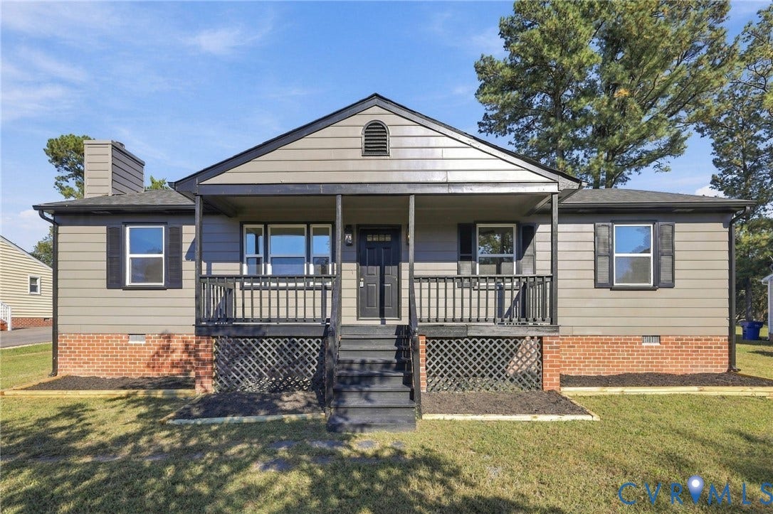 5113 Olympic Lane, North Dinwiddie, VA 23803 Siding exterior with brick foundation, covered porch with dark railings, and a prominent front door