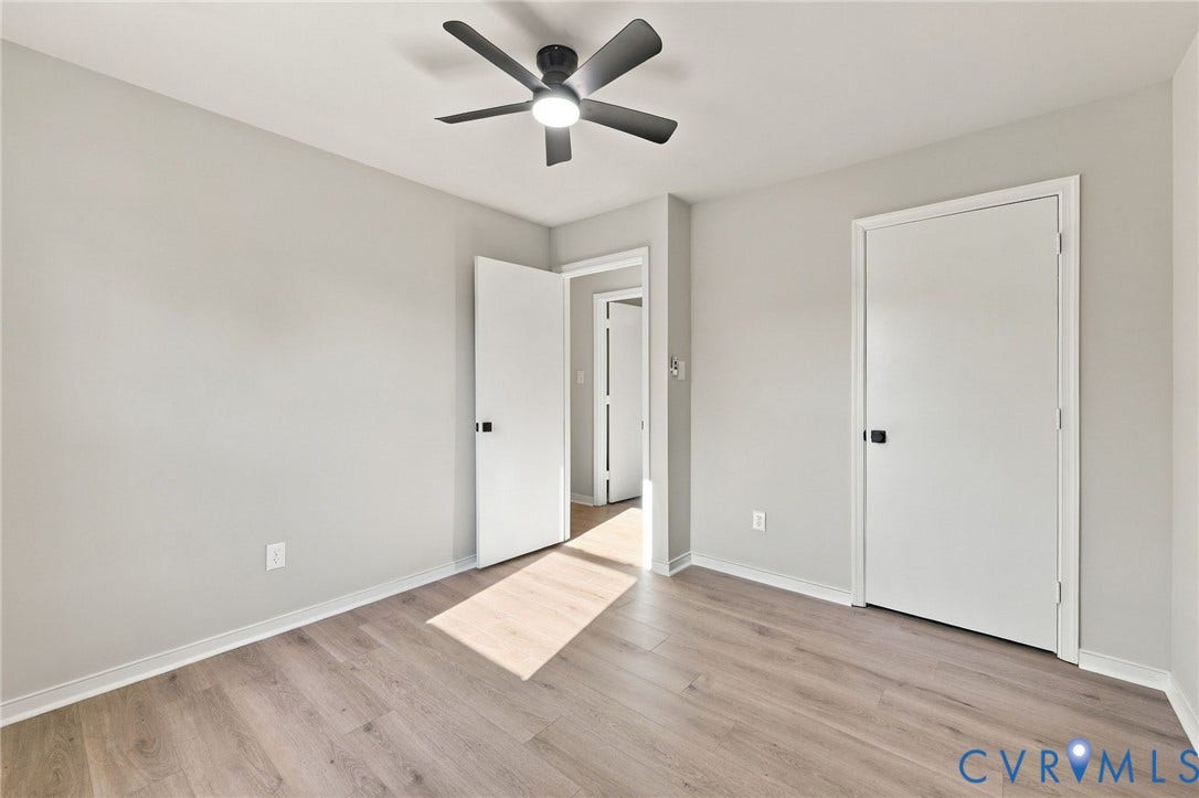 5113 Olympic Lane, North Dinwiddie, VA 23803 Wood-finish flooring, light grey walls, white trim, and a ceiling fan with integrated lighting