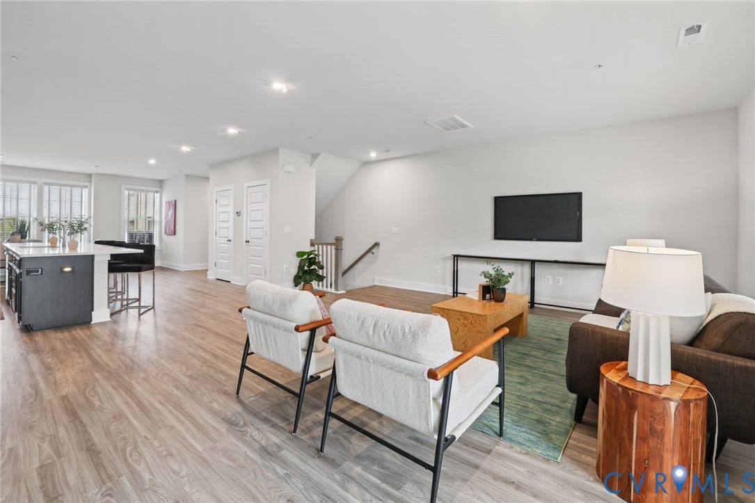 597 Weaver Brook Walk, #B, Richmond, VA 23233 Open-concept floor plan featuring wood-finish flooring, recessed lighting, and a kitchen island with stone-style countertops