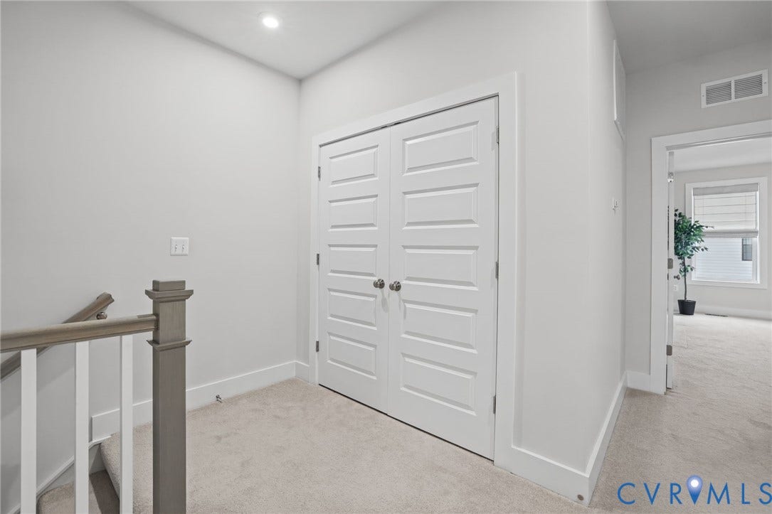 597 Weaver Brook Walk, #B, Richmond, VA 23233 White five-panel double doors, neutral carpeting, and a wooden handrail with vertical balusters