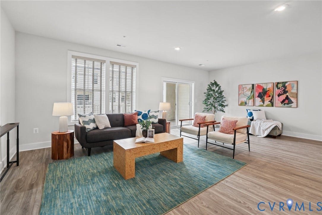 597 Weaver Brook Walk, #B, Richmond, VA 23233 Open-concept living space featuring wood-finish flooring, recessed lighting, double-paned windows with horizontal blinds, and a sliding glass door