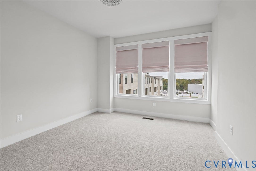 597 Weaver Brook Walk, #B, Richmond, VA 23233 Room featuring wall-to-wall carpeting and a triple-window configuration with installed fabric shades and overhead crystal-style light fixture