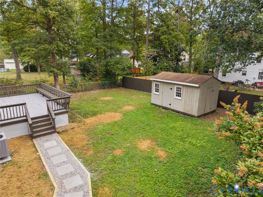2031 Esquire Road, Midlothian, VA 23235 Expansive backyard featuring a multi-level deck, a gravel pathway with stepping stones, and a storage shed